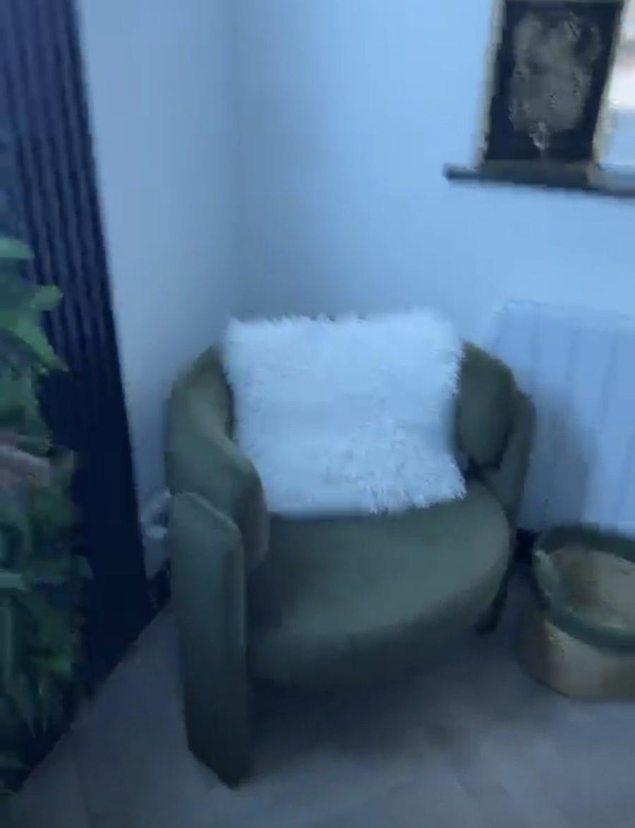 Green velvet chair with a white cushion in the clinic